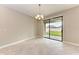 Bright dining area with sliding glass doors that open to the back yard and patio at 9917 Ivory Dr, Ruskin, FL 33573