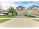 Charming two-story home boasts a well-manicured lawn, paver driveway, and attached two-car garage at 9917 Ivory Dr, Ruskin, FL 33573