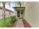 Inviting front porch with manicured landscaping and a brick walkway leads to the front door at 9917 Ivory Dr, Ruskin, FL 33573