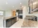 Modern kitchen featuring granite countertops, stainless steel appliances and dark cabinetry at 9917 Ivory Dr, Ruskin, FL 33573