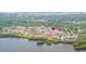 Aerial view showcasing the community near a serene lake and lush greenery at 10034 64Th N Ave # 14, St Petersburg, FL 33708