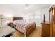 Comfortable bedroom with wooden furniture, a ceiling fan, and bright natural lighting at 10034 64Th N Ave # 14, St Petersburg, FL 33708