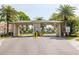 Gated community entrance with manicured landscaping and convenient access at 10034 64Th N Ave # 14, St Petersburg, FL 33708