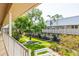Serene community courtyard featuring well-maintained landscaping, lush greenery, and seating area at 10034 64Th N Ave # 14, St Petersburg, FL 33708