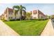 Well-maintained building exterior surrounded by a lush green lawn and mature landscaping at 10034 64Th N Ave # 14, St Petersburg, FL 33708