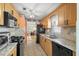 Well-equipped kitchen features stainless steel appliances, granite countertops, wood cabinets, and tile flooring at 10034 64Th N Ave # 14, St Petersburg, FL 33708