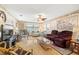 Comfortable living room with hardwood floors, ceiling fan, wall art, and a variety of seating options at 10034 64Th N Ave # 14, St Petersburg, FL 33708