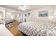 Bright main bedroom with hardwood floors, ceiling fan, large window, mirrored closets, and ensuite bathroom at 10034 64Th N Ave # 14, St Petersburg, FL 33708