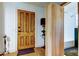 Inviting entryway showcasing the wood door and built-in shelving leading to the bathroom at 1006 E River Cove St, Tampa, FL 33604