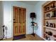 Inviting entryway featuring a wood door, hardwood floors, and a built-in bookshelf at 1006 E River Cove St, Tampa, FL 33604