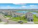 Aerial view showcasing home's curb appeal, landscaping, and proximity to community lake at 10914 Penny Gale Loop, San Antonio, FL 33576
