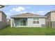 Backyard with lush lawn and covered patio, perfect for relaxing or entertaining at 10914 Penny Gale Loop, San Antonio, FL 33576