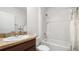 Clean bathroom with a shower-tub combo, vanity with granite countertops and white walls at 10914 Penny Gale Loop, San Antonio, FL 33576