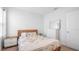 Bright bedroom with a plush bed, dresser, bedside table, and natural light at 10914 Penny Gale Loop, San Antonio, FL 33576