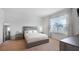 Bright bedroom features neutral colors, large windows, and plush carpet at 10914 Penny Gale Loop, San Antonio, FL 33576