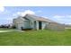 Single Gathering home with a green lawn, driveway, and an attached two-car garage at 10914 Penny Gale Loop, San Antonio, FL 33576