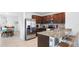 Modern kitchen features stainless steel appliances, granite countertops, and rich wood cabinetry at 10914 Penny Gale Loop, San Antonio, FL 33576