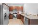 Bright kitchen features stainless steel appliances, stylish backsplash, and granite countertops at 10914 Penny Gale Loop, San Antonio, FL 33576