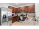 Modern kitchen features stainless steel appliances, mosaic backsplash, and stone countertops at 10914 Penny Gale Loop, San Antonio, FL 33576