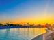 Relax by the water at the lagoon featuring lounge chairs, a beach, and a sunset view at 10914 Penny Gale Loop, San Antonio, FL 33576