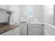 A well-lit laundry room featuring modern appliances, storage cabinets, and countertop space at 10914 Penny Gale Loop, San Antonio, FL 33576