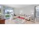 Bright living room with neutral colors, modern furniture, and large windows at 10914 Penny Gale Loop, San Antonio, FL 33576