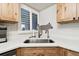 Kitchen sink and window area featuring custom wooden cabinetry and stainless steel appliances at 11440 Harbor Way # 5009, Largo, FL 33774