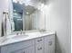 Bathroom featuring a double vanity with marble countertops and modern fixtures at 120 Moscata Way, Nokomis, FL 34275