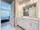 Bathroom featuring a double vanity with marble countertops, open to the bedroom at 120 Moscata Way, Nokomis, FL 34275