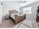 This bedroom features an ornate wood bed frame, plush carpeting, and a ceiling fan for added comfort at 120 Moscata Way, Nokomis, FL 34275