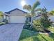 Charming single-story home with a brick driveway and well-manicured landscaping with lush green grass at 120 Moscata Way, Nokomis, FL 34275
