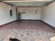 Spacious garage featuring epoxy flooring, water heater, breaker box and inside access door at 120 Moscata Way, Nokomis, FL 34275