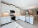 Modern kitchen features white cabinets, stainless steel appliances, and granite countertops with island at 120 Moscata Way, Nokomis, FL 34275