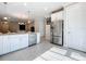 Open kitchen boasts stainless steel appliances and white cabinetry with seamless flow to the living areas at 120 Moscata Way, Nokomis, FL 34275