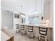 Kitchen island featuring seating, modern pendant lights, and stylish cabinetry at 120 Moscata Way, Nokomis, FL 34275