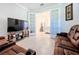 Inviting living area featuring French doors, comfortable seating, and an entertainment setup at 120 Moscata Way, Nokomis, FL 34275