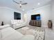 Cozy living room with neutral colors, ceiling fan, and recessed lighting at 120 Moscata Way, Nokomis, FL 34275