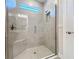 Modern glass shower showcasing sleek tiling and a convenient built-in seat at 120 Moscata Way, Nokomis, FL 34275