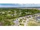 Aerial view of a well-maintained neighborhood with lush greenery and a clear blue sky in the background at 12328 Streambed Dr, Riverview, FL 33579