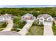 Gorgeous two-story home with a well-manicured lawn and mature trees, surrounded by lush greenery at 12328 Streambed Dr, Riverview, FL 33579
