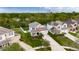 Aerial view of a home with a well-maintained yard, nestled in a lush neighborhood with mature trees at 12328 Streambed Dr, Riverview, FL 33579
