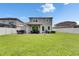 Spacious backyard featuring a well-manicured lawn, a patio with seating, and a pristine white fence at 12328 Streambed Dr, Riverview, FL 33579