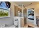 Bathroom featuring glass-enclosed shower and view of the bedroom at 12328 Streambed Dr, Riverview, FL 33579