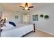 Bedroom with ceiling fan, blue accent pillows and a light and airy atmosphere at 12328 Streambed Dr, Riverview, FL 33579