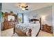 Charming bedroom with a wooden bed frame, dresser, and ample natural light at 12328 Streambed Dr, Riverview, FL 33579
