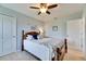 Cozy bedroom features a wooden bed frame, ceiling fan, and neutral walls at 12328 Streambed Dr, Riverview, FL 33579