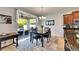 Bright dining area features a modern chandelier and outdoor access with a patio view at 12328 Streambed Dr, Riverview, FL 33579