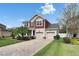 Charming two-story home with a well-manicured lawn, brick driveway, and inviting curb appeal at 12328 Streambed Dr, Riverview, FL 33579