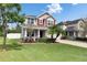 Charming two-story home with a well-manicured lawn and inviting curb appeal at 12328 Streambed Dr, Riverview, FL 33579