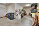Spacious garage interior offering ample storage and utility space with access to a workshop area at 12328 Streambed Dr, Riverview, FL 33579